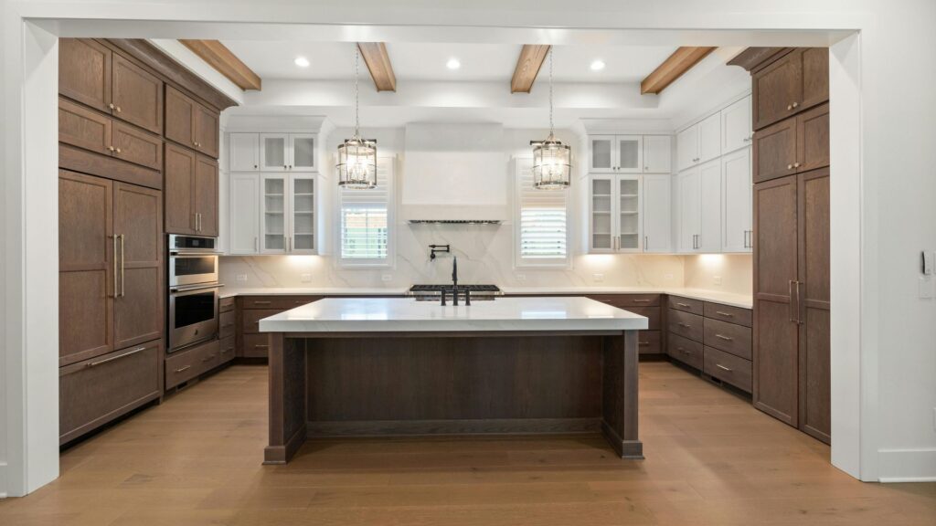 Walnut and white custom kitchen cabinets with large island