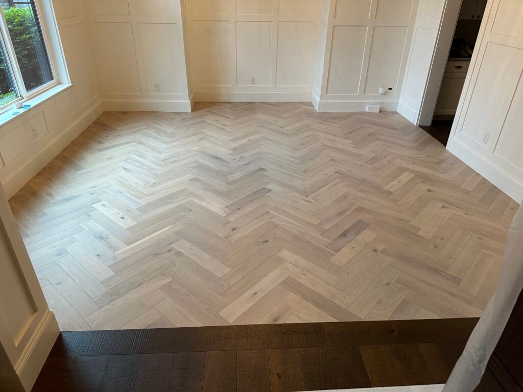Light oak herringbone hardwood floor installation