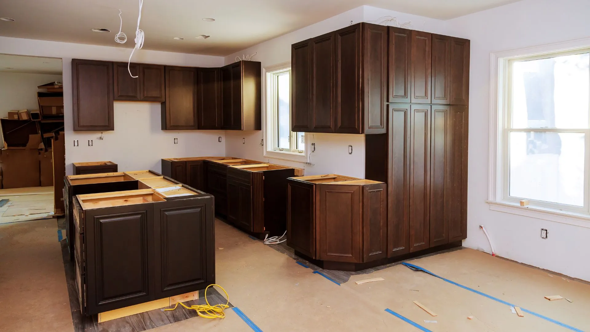 Inside of an older particleboard base cabinet with water swelling near the sink, photographed during a Bellevue, WA kitchen consultation by Custom Touch Interiors